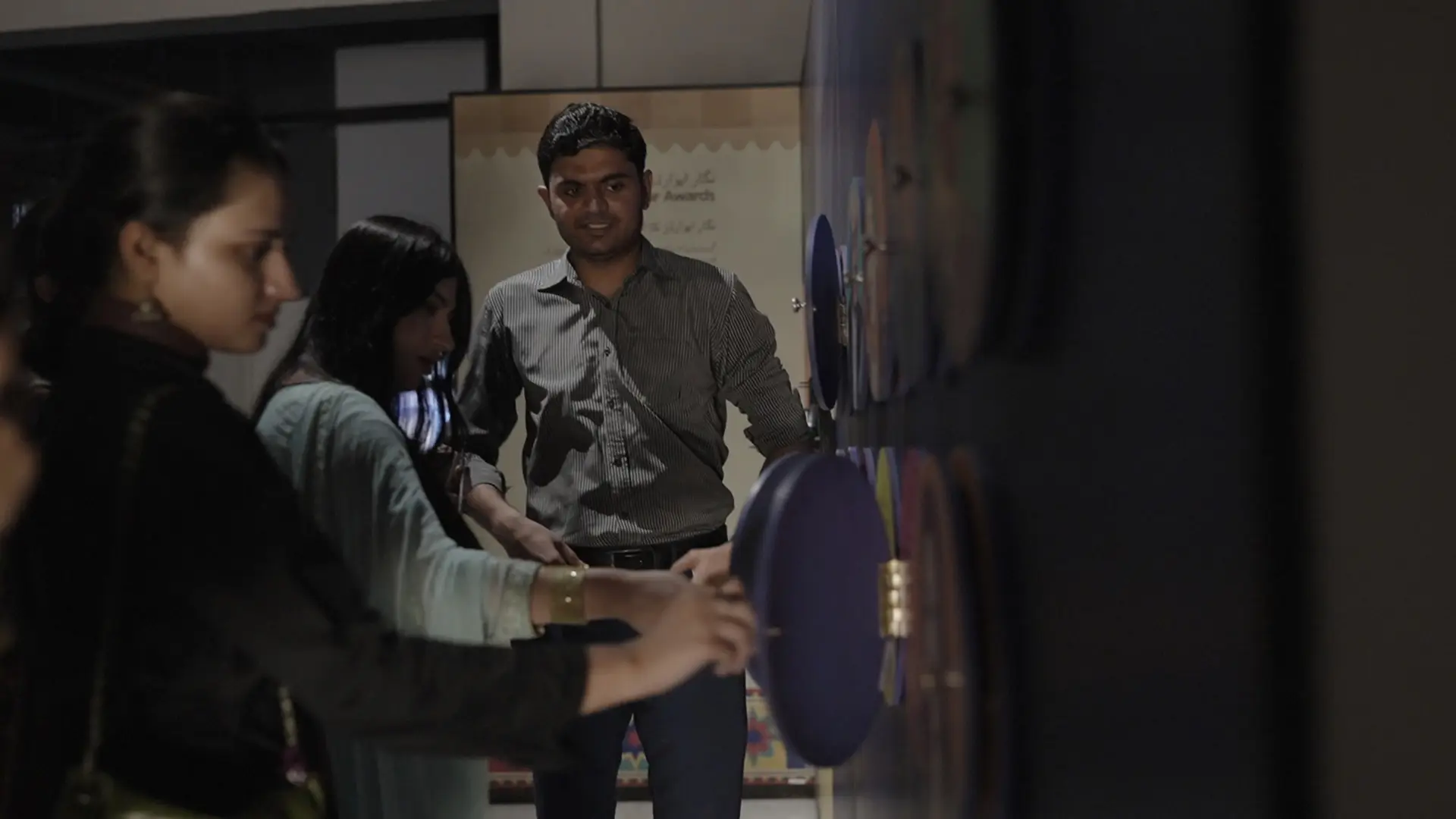 Participants interact with a hands-on exhibit during the museum visit