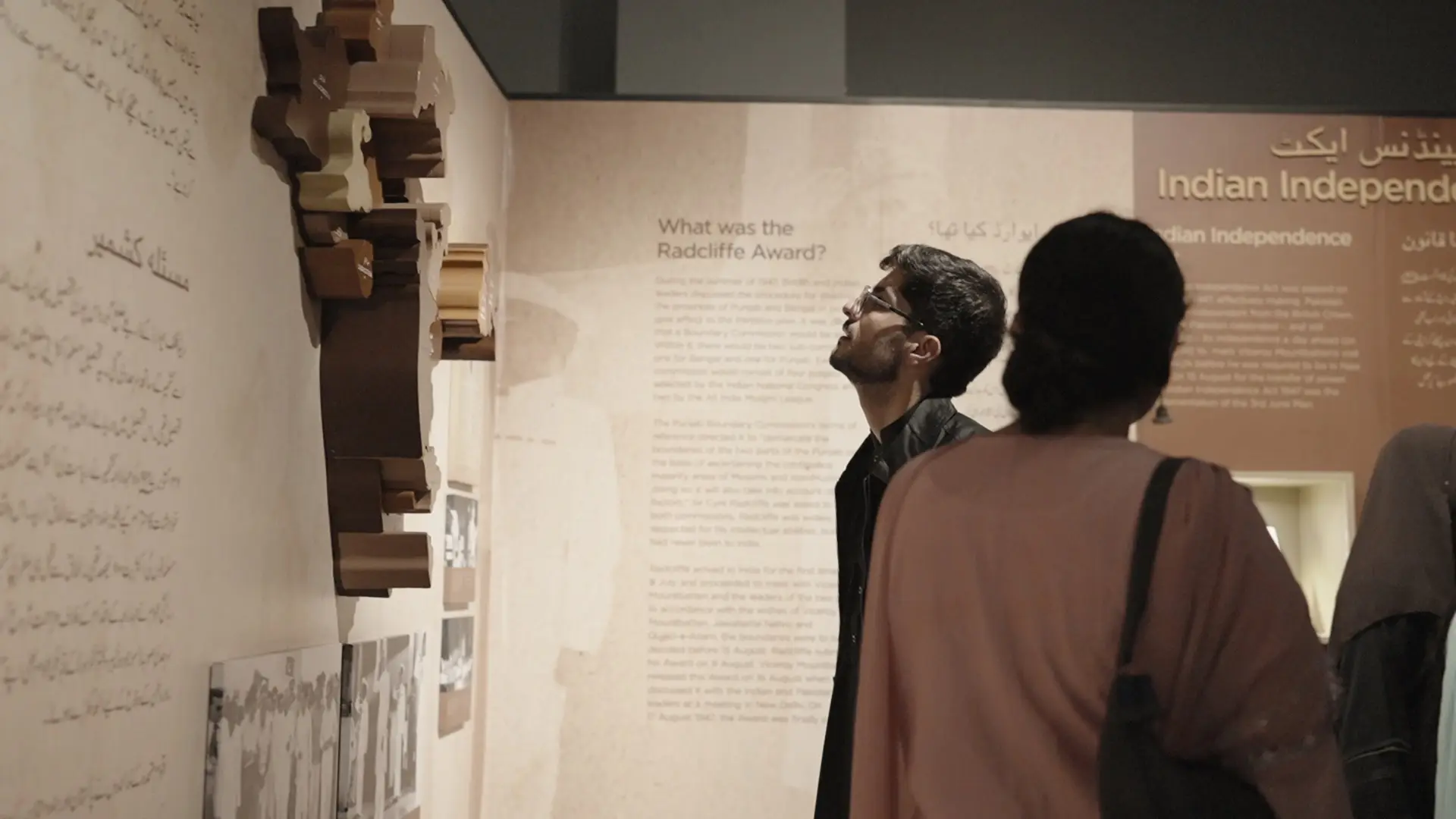 Participants study an exhibit on the Radcliffe Award at a museum of Partition